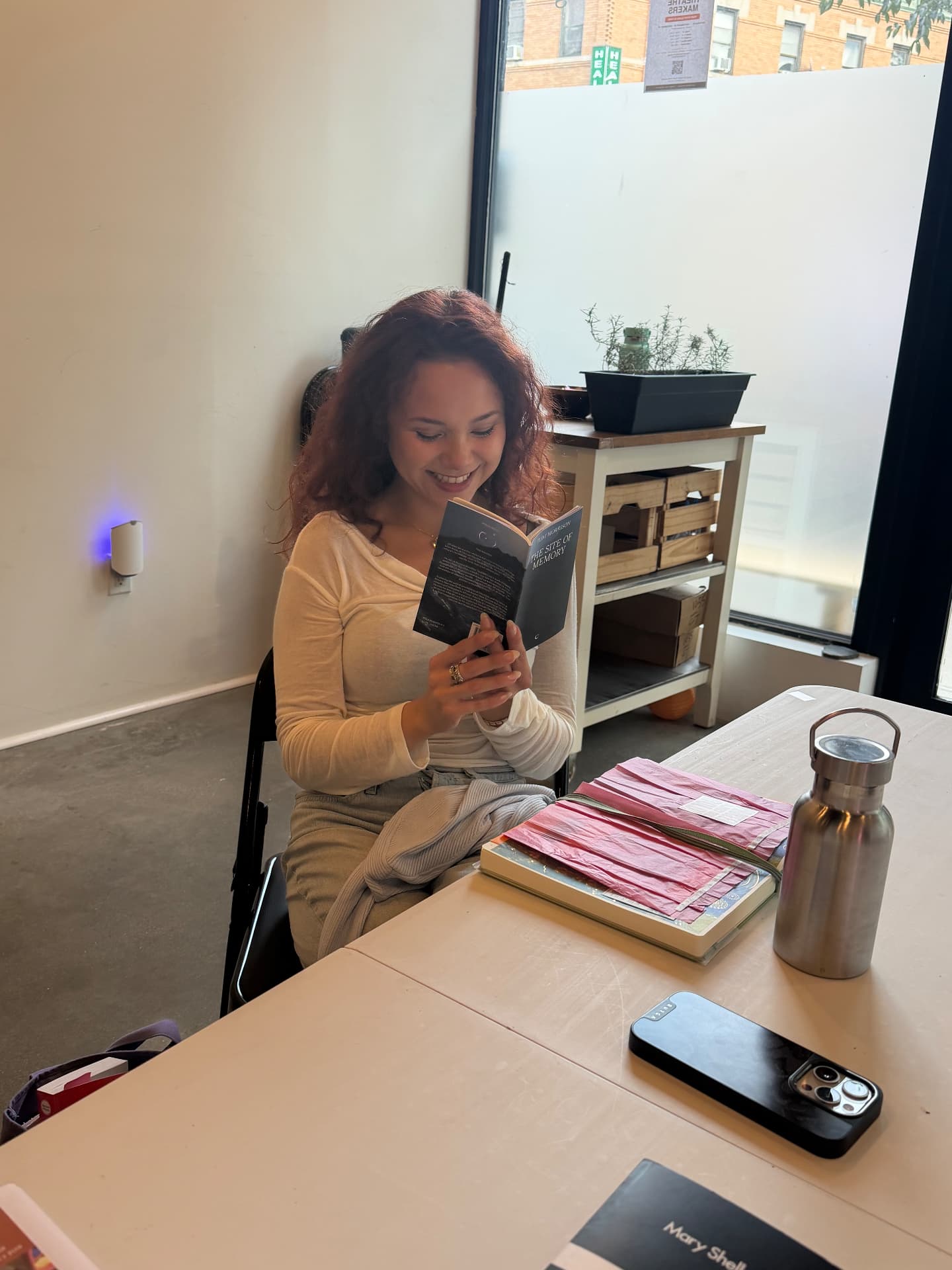 A co-worker reading by the front windows at RISE, Ditmas Park